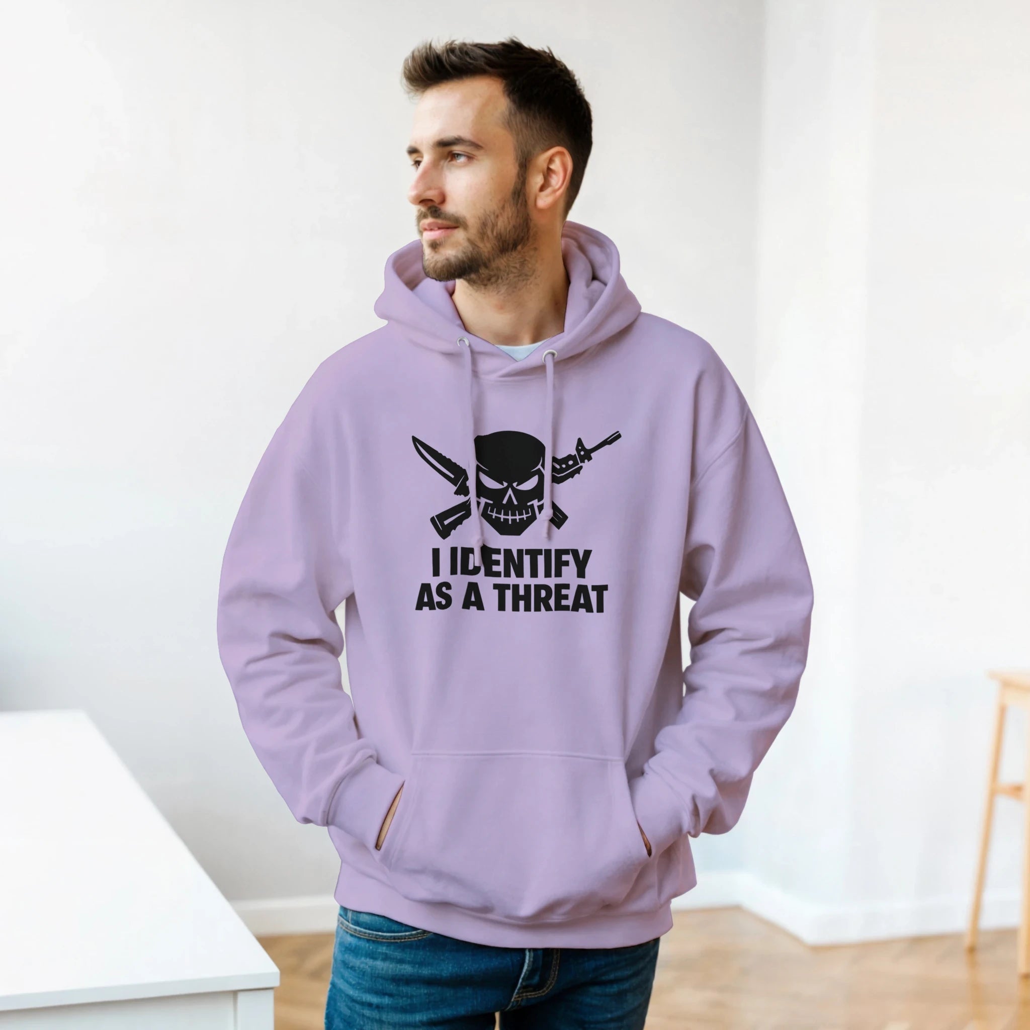 classic pullover hoodie gildan 18500 heavy blend model wearing lavender hoodie with skull and crossed swords design, reads I IDENTIFY AS A THREAT