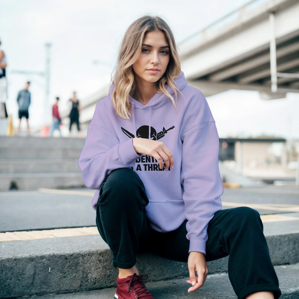 classic pullover hoodie gildan 18500 heavy blend - model wearing lavender hoodie with front graphic, sitting on steps in urban setting